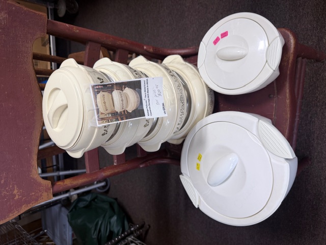 Stacked set of vintage cream-colored enameled ceramic covered casserole storage dishes with lids